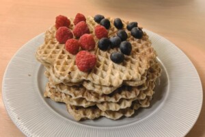 Healthy Oat waffles served with blueberries and raspberries.