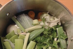Cold water into the pot with ingredients for chicken stock.