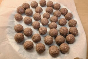 Shaped meatballs on a tray.