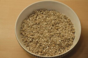 Almond butter is folded into the dry mixture to make granola.