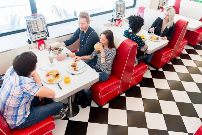 Friends dining at a diner, conscious of their food choices, may not fully grasp the extent to which ultra-processed foods have made it to their table.