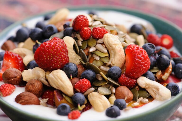 A vibrant bowl of yogurt topped with fresh berries, nuts, and seeds is one of the easiest Mediterranean diet breakfast ideas packed with protein and antioxidants.
