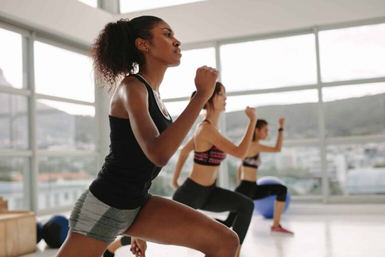 Women exercising together in a light-filled studio, reflecting strong exercise motivation among women.