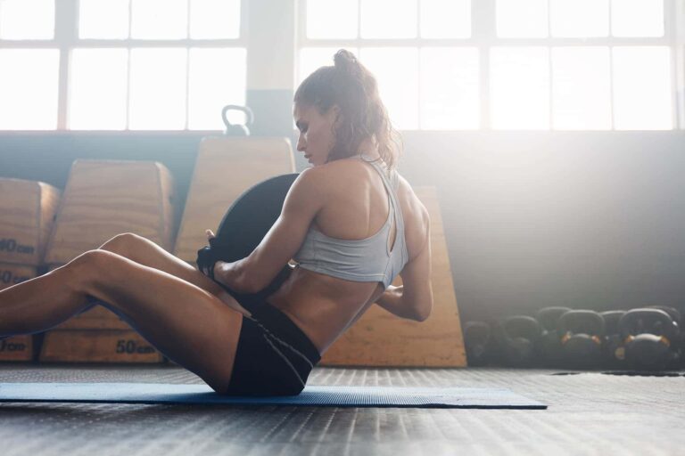 A woman embraces her exercise routines as she does strength training, determined to feel strong and confident.