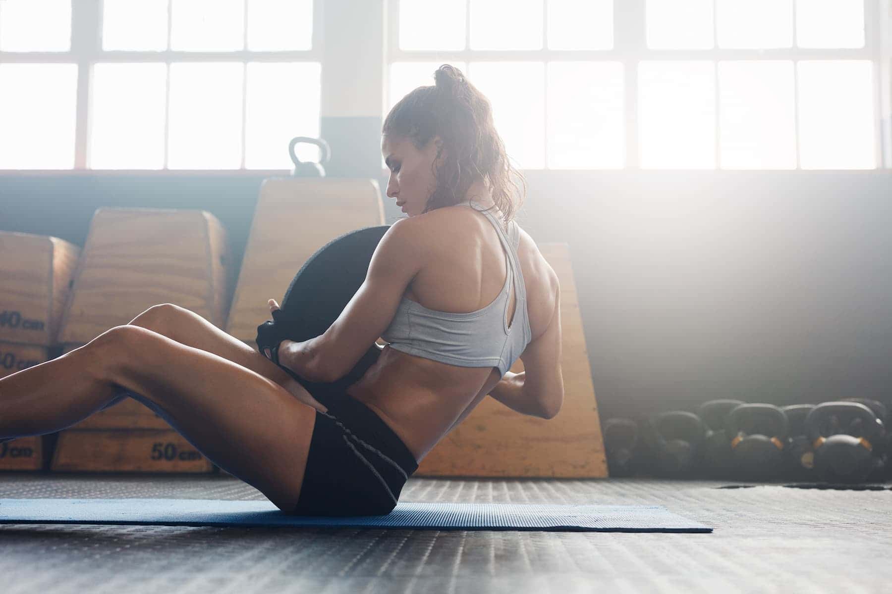 A woman embraces her exercise routines as she does strength training, determined to feel strong and confident.