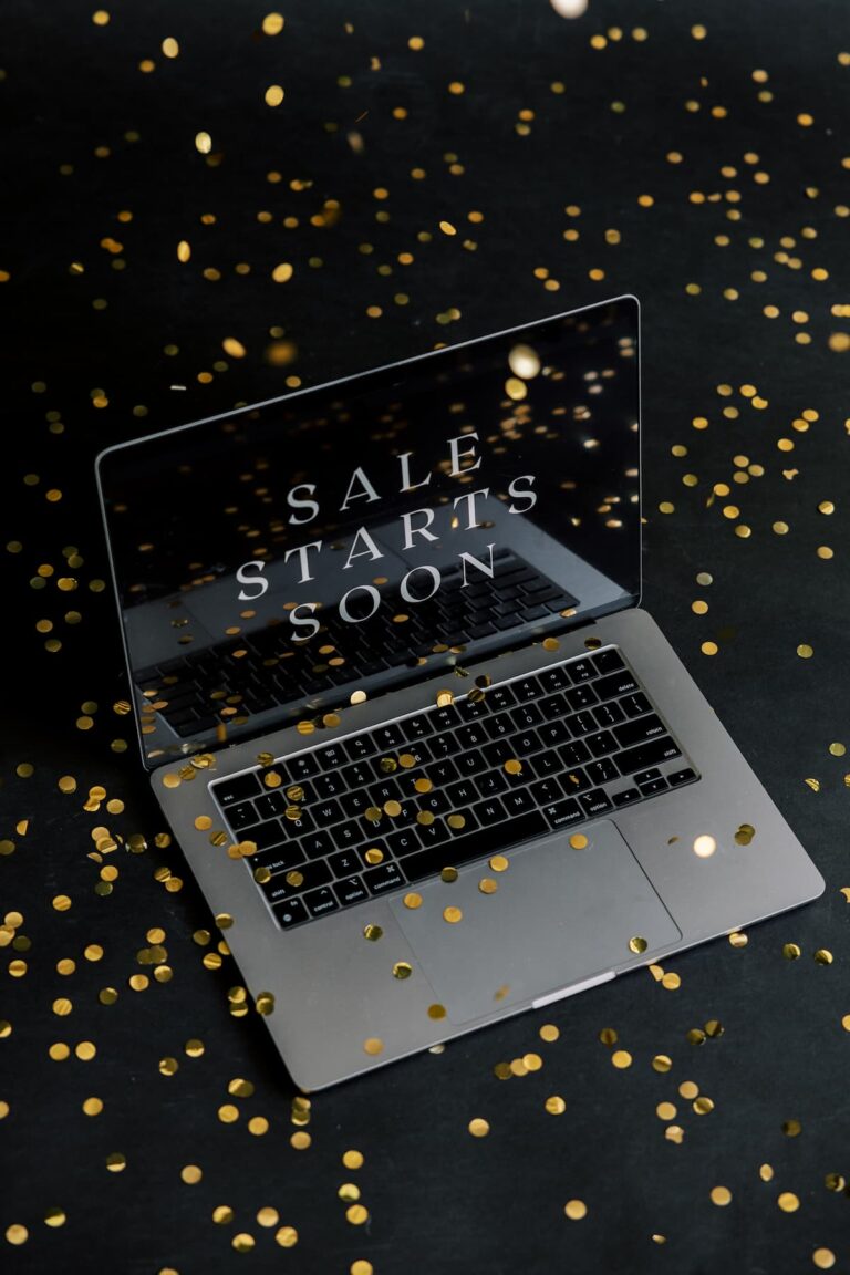 A laptop displaying "SALE STARTS SOON" surrounded by gold confetti on a black background highlighting Black Fridays deals for bloggers.