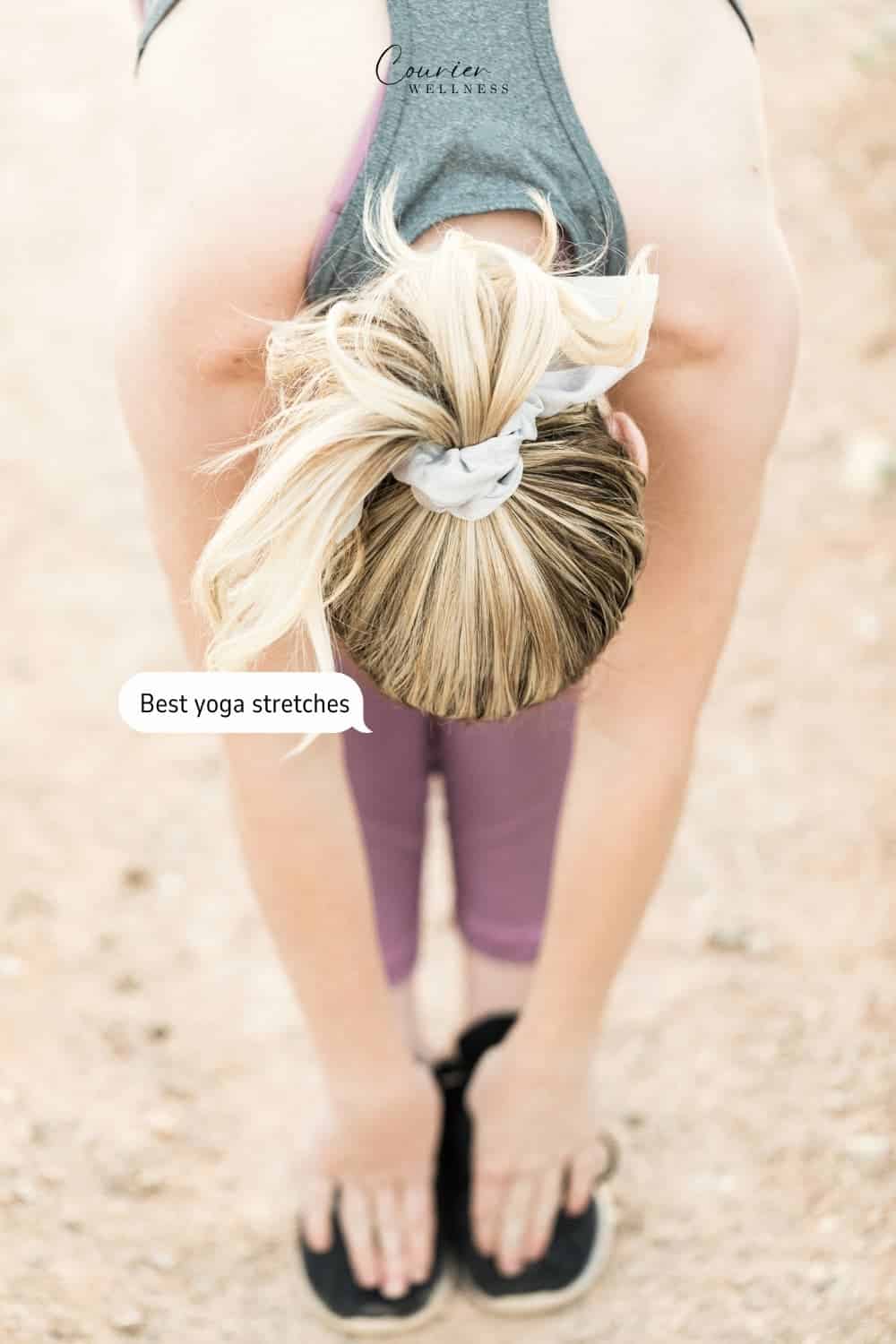 Woman stretching forward to touch her toes in a desert environment.