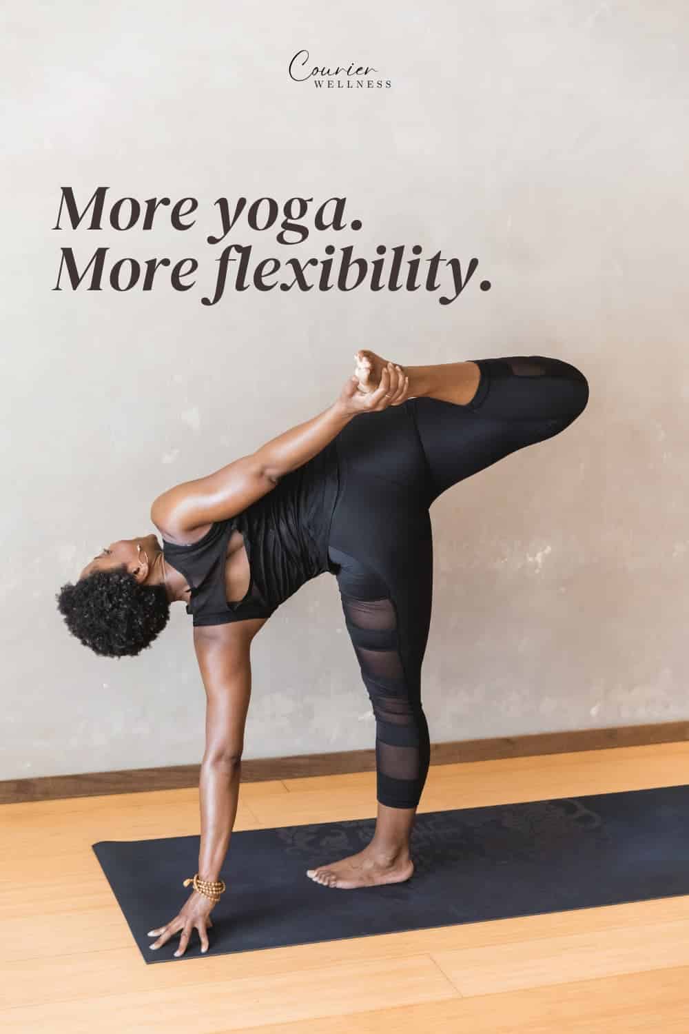 Woman in black athletic wear balancing on one leg in an advanced yoga pose.