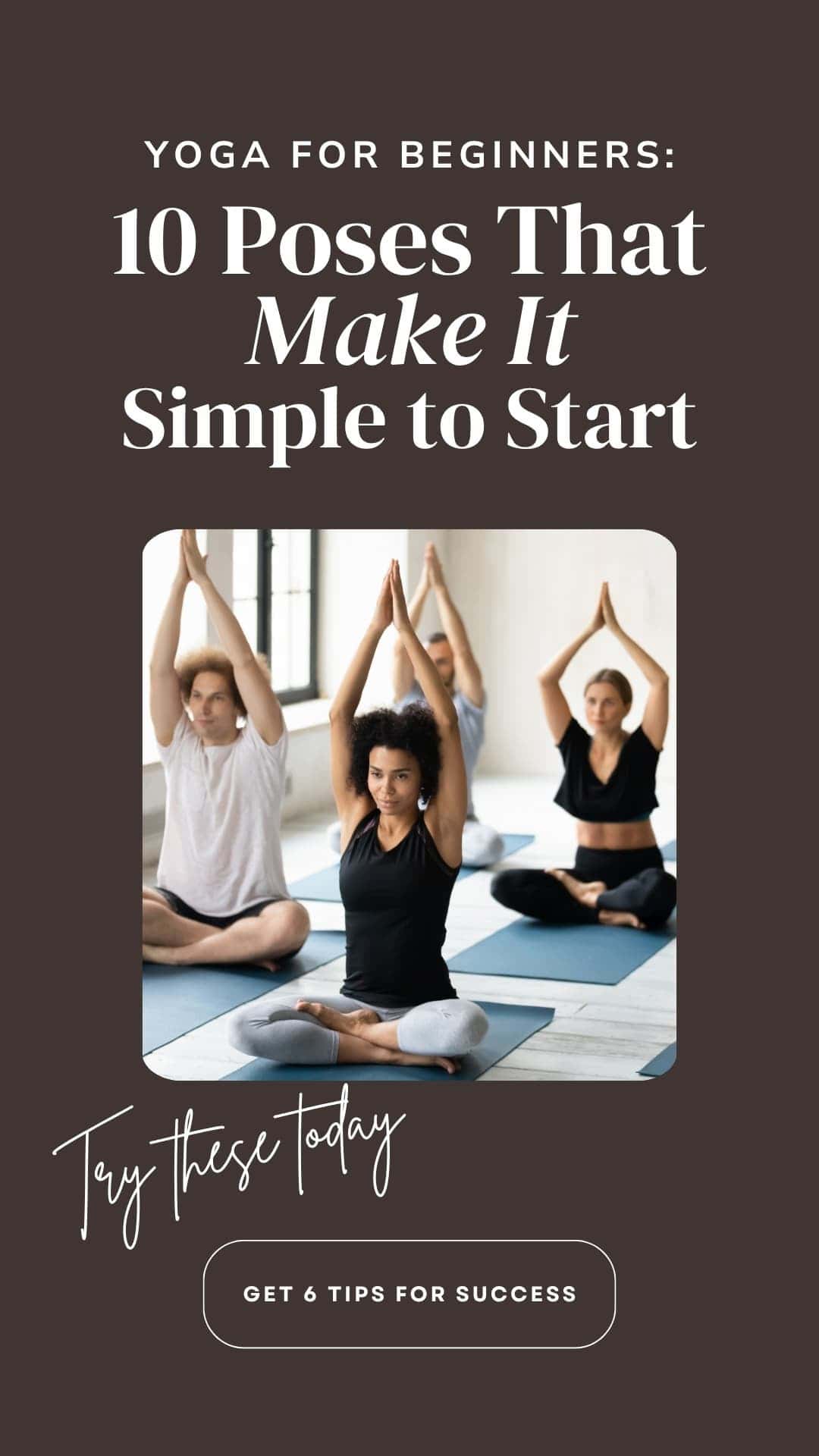 Group of people meditating in a yoga studio with hands raised in a calm, focused pose.