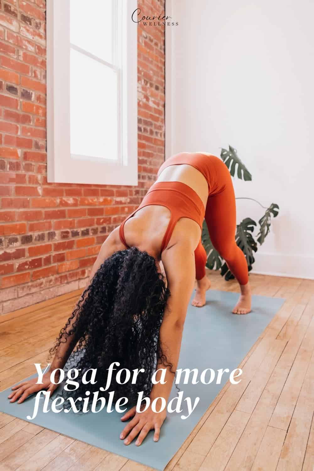 Woman in burnt orange yoga outfit practicing a pose indoors.